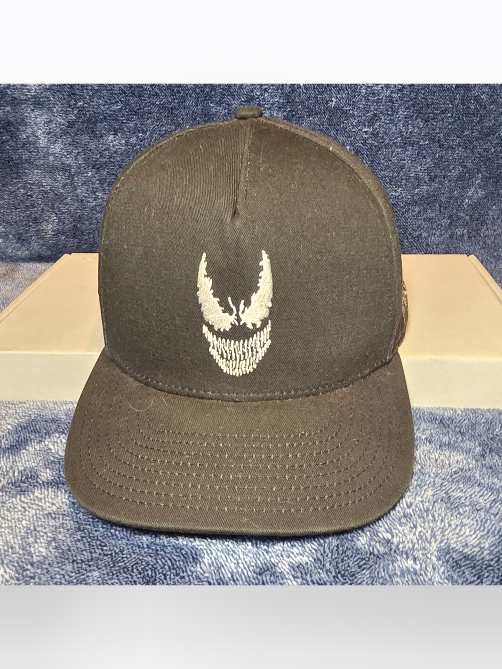 Black Baseball Cap with White Face Emblem